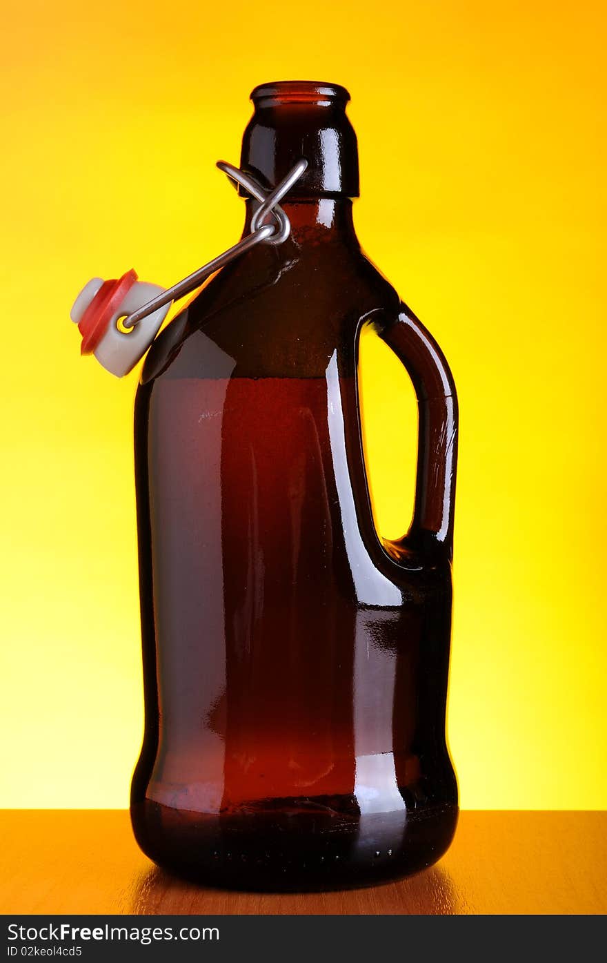 Old beer bottle on yellow background