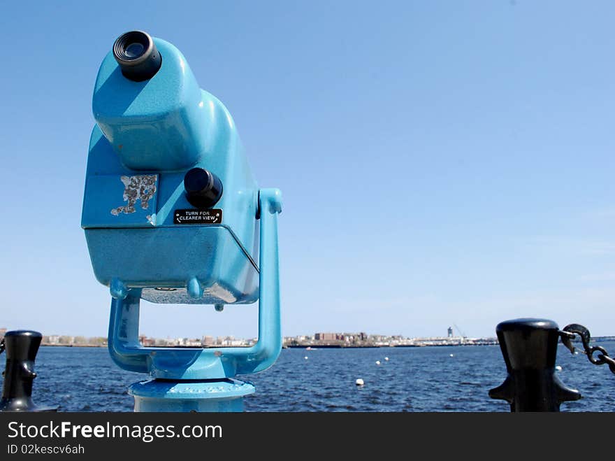 Sightseeing binoculars in the Bay of Boston, with view on the airport of the city