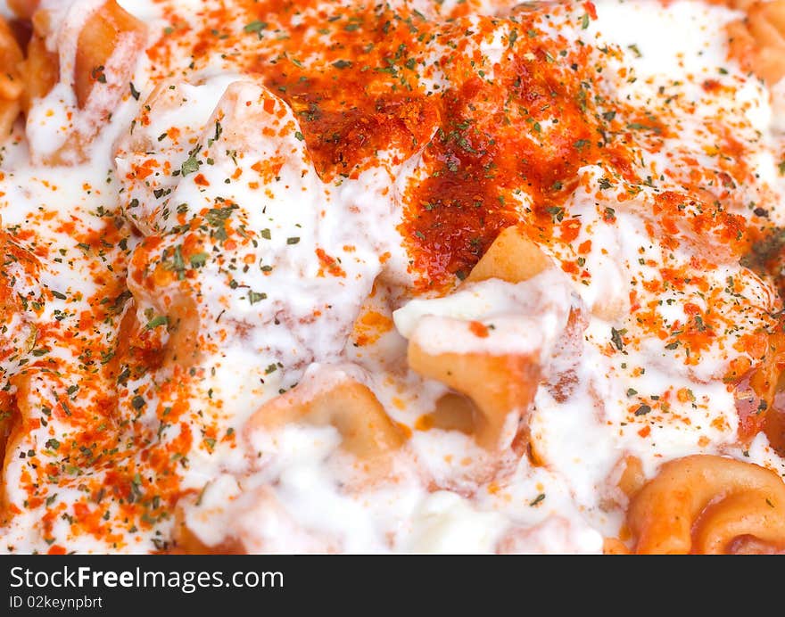 Turkish ravioli with spices and yogurt background