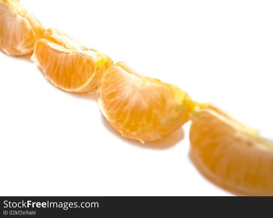 Row of mandarin segments isolated over white