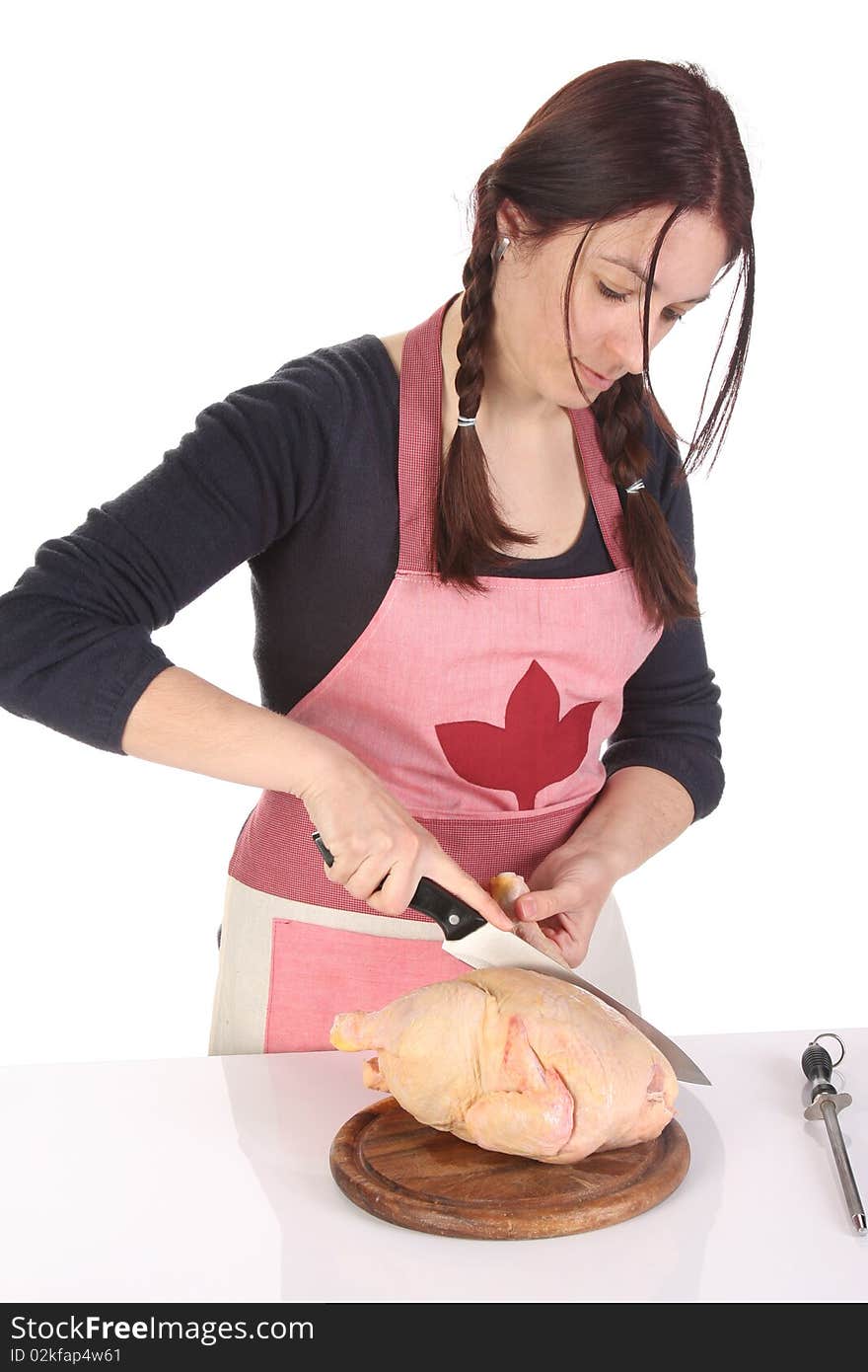 Beautiful housewife cutting chicken