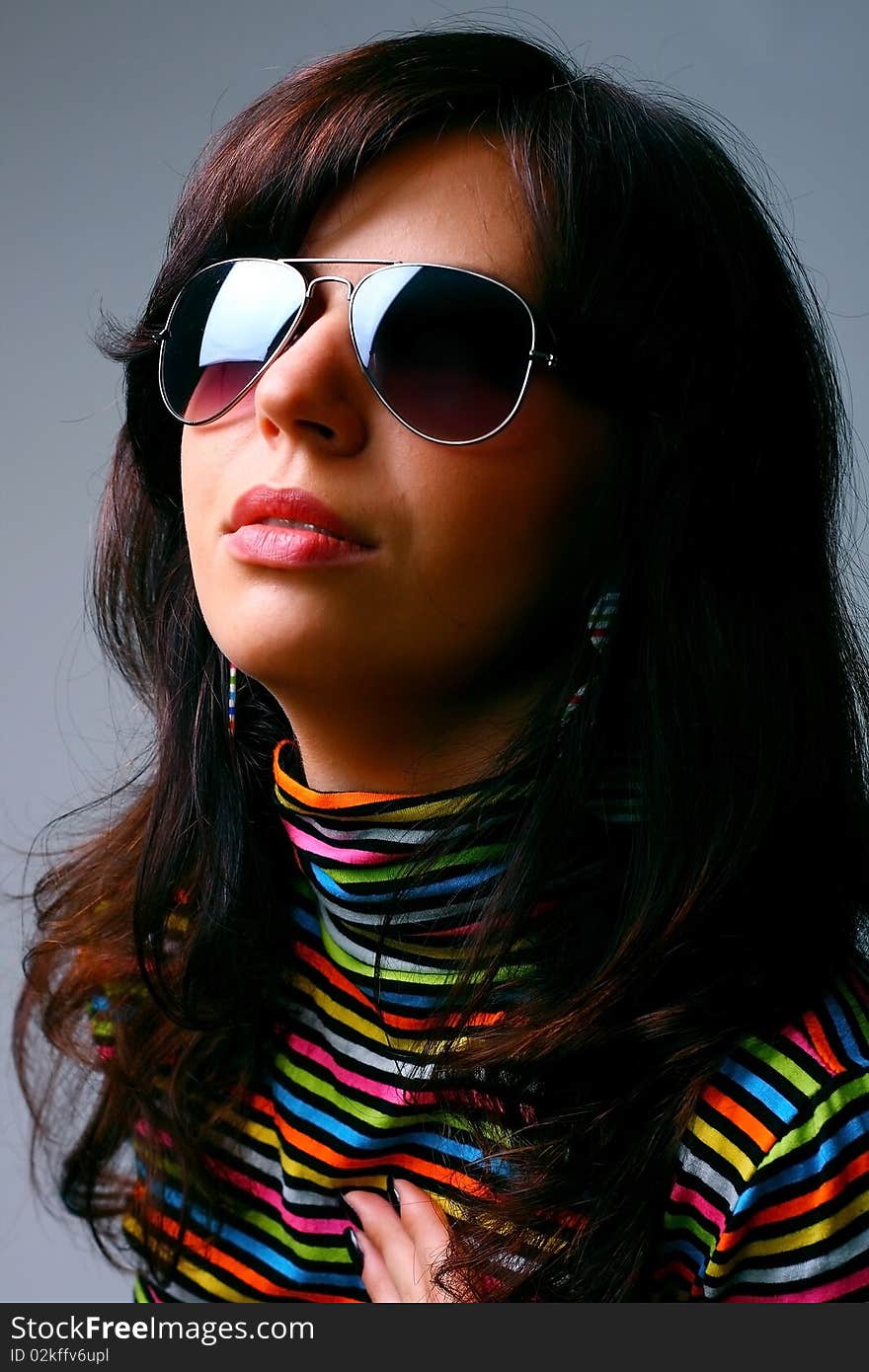 Studio shot of beautiful woman with stylish glasess