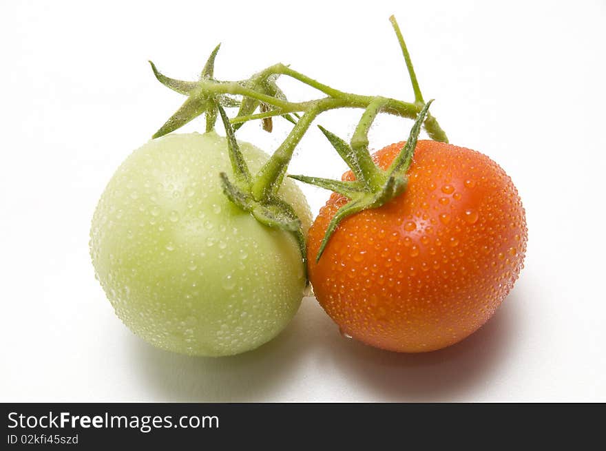 The two fresh tomato on the white background