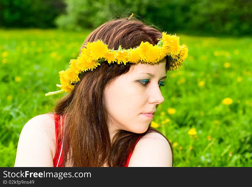 Portrait of young woman in dandelion garland. Portrait of young woman in dandelion garland