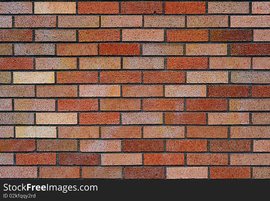 Clean red and tan brick wall background texture.