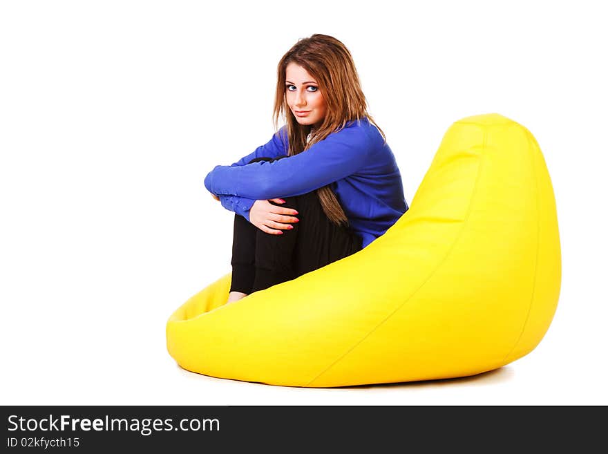 Picture of a attractive young girl in blue on armchair. Isolated on white. Picture of a attractive young girl in blue on armchair. Isolated on white.