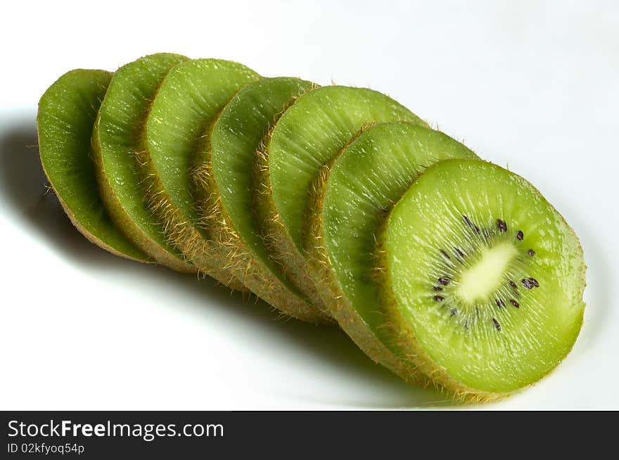 Sliced kiwi over white plate macro shot