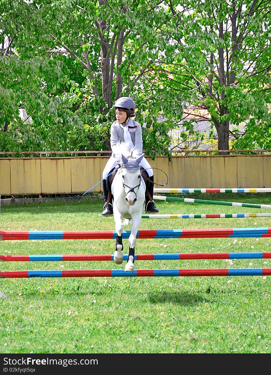 Young Boy Riding White Horse