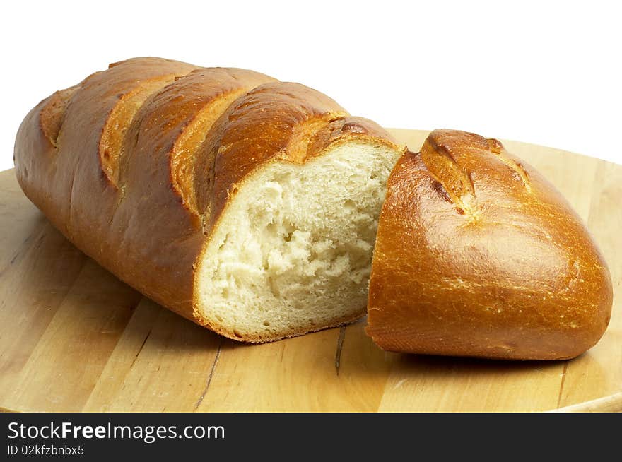 Shiny long bread sliced over wooden desk background