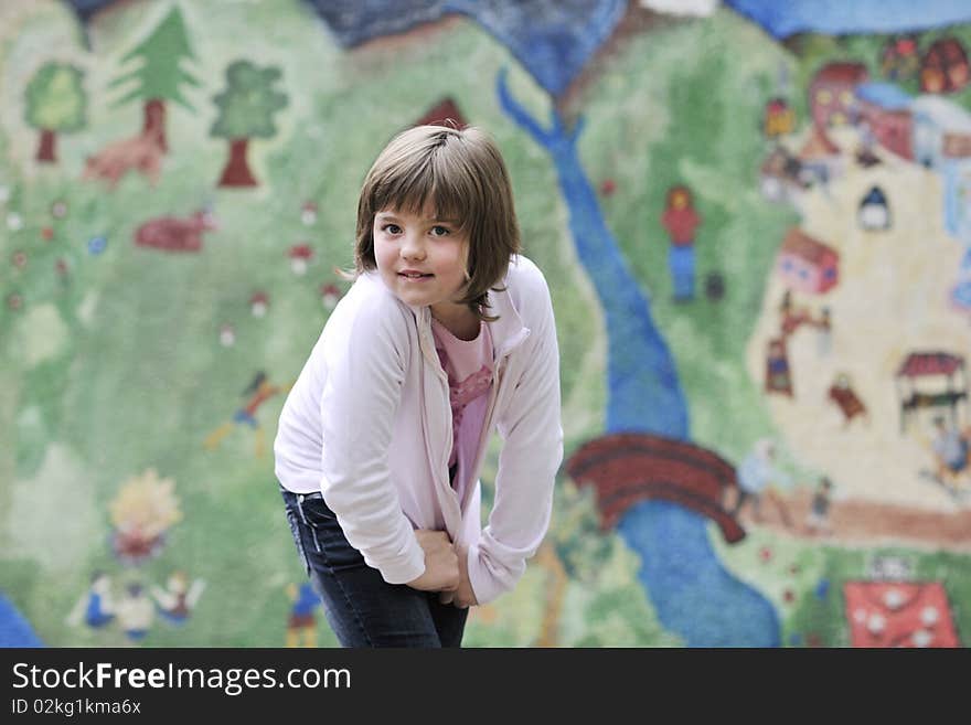 Happy young girl posing and jumping with abstract urban style painting bacground begind. Happy young girl posing and jumping with abstract urban style painting bacground begind