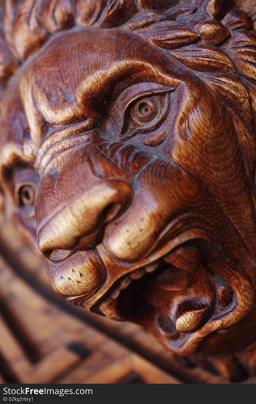 Big wooden head of lion on the front door