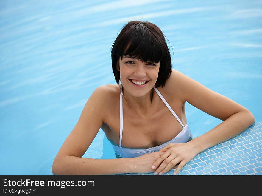 Closeup of beautiful young woman in a swimming pool. Closeup of beautiful young woman in a swimming pool