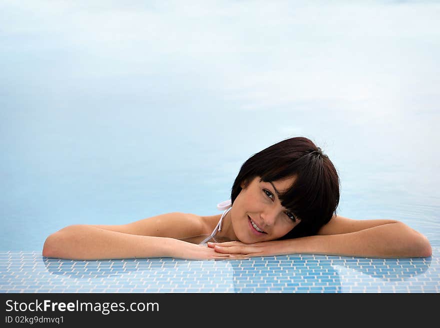 Closeup of beautiful young woman in a swimming pool. Closeup of beautiful young woman in a swimming pool