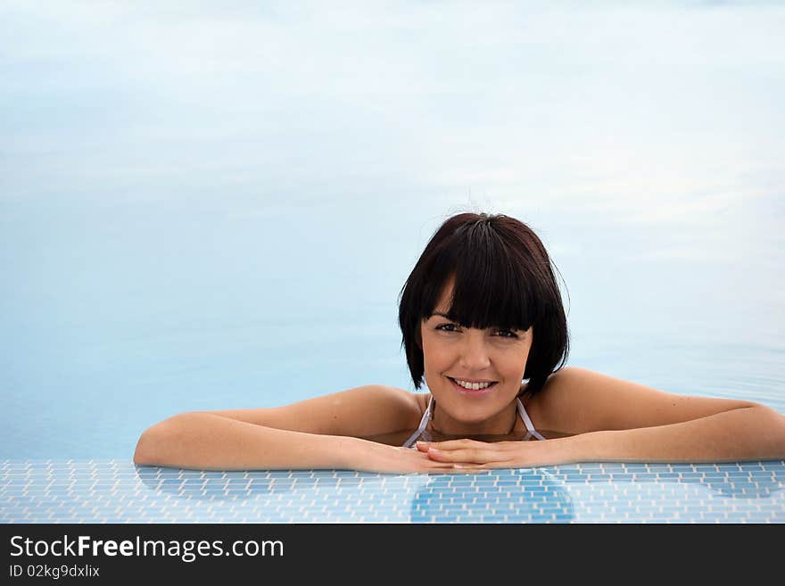 Closeup of beautiful young woman in a swimming pool. Closeup of beautiful young woman in a swimming pool