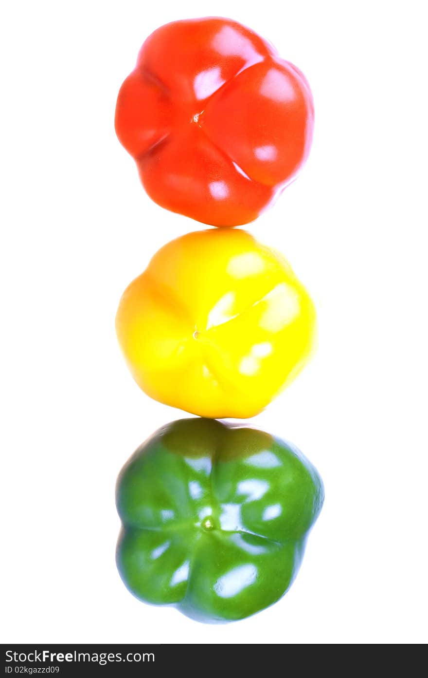 Red, yellow and green sweet peppers isolated on white background