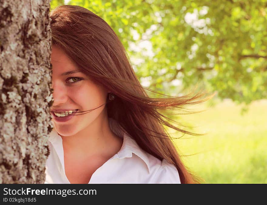 Smiling girl and old oak