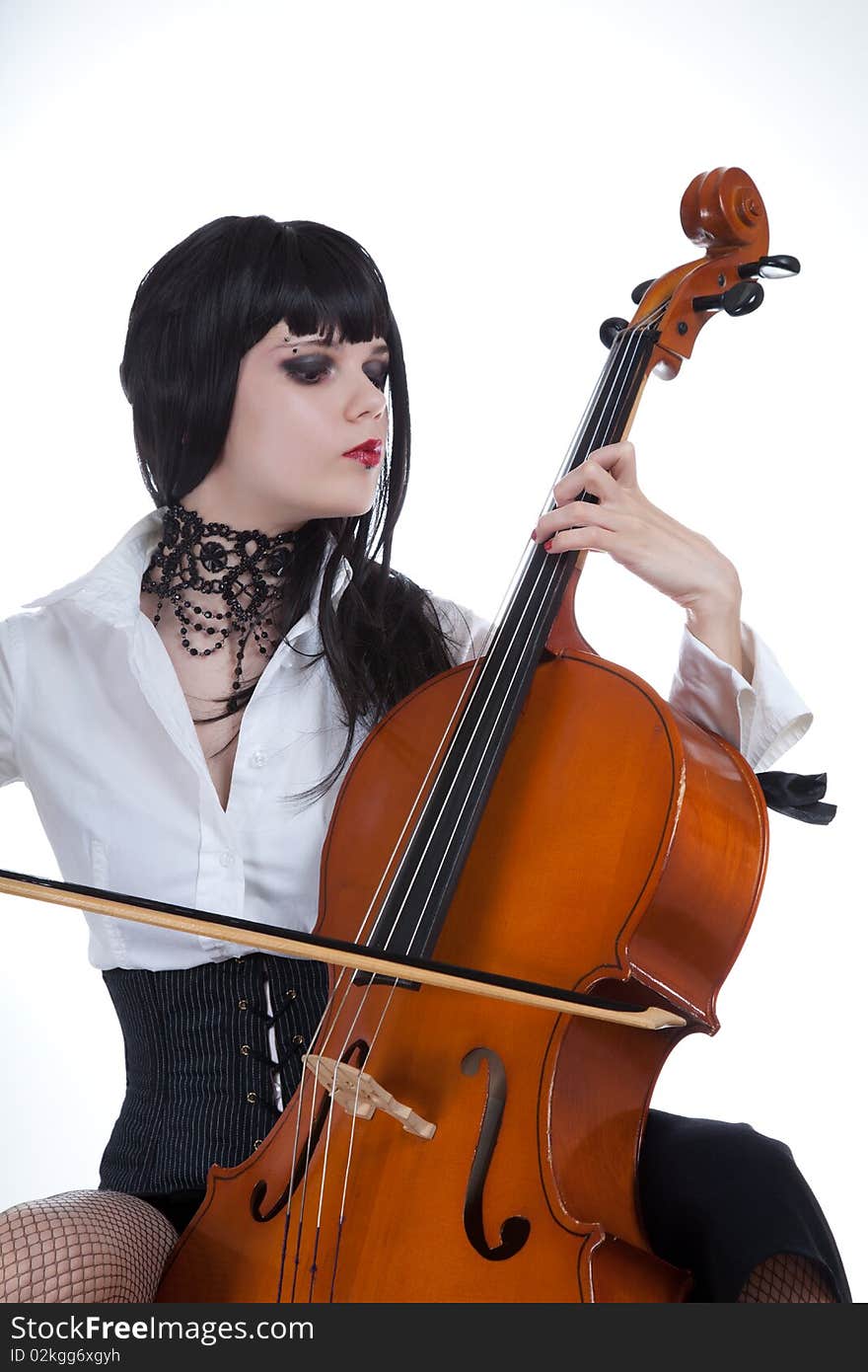 Attractive girl playing cello, studio shot over white background