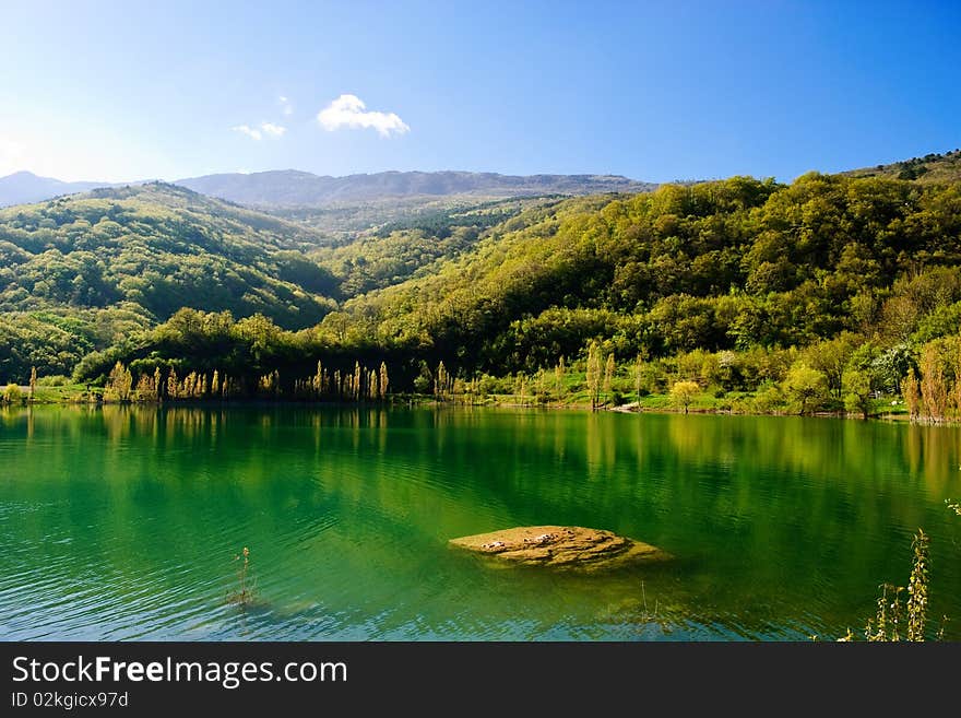 Stone under water in mountain lake. Stone under water in mountain lake