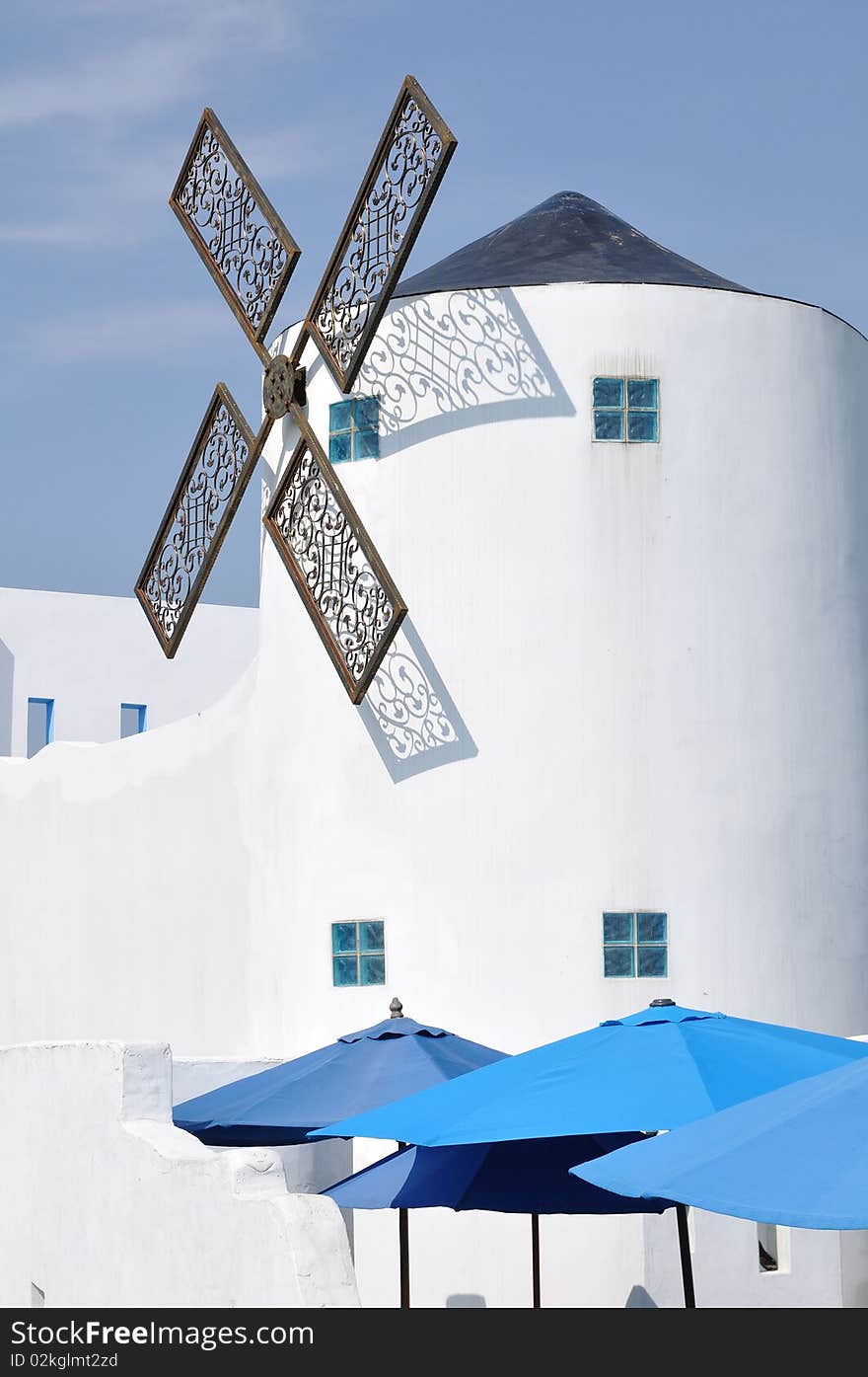 It is a white house with the windmill