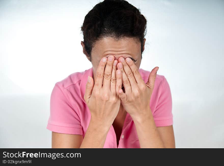 Woman in pain, rubbing forehead with hands. Woman in pain, rubbing forehead with hands