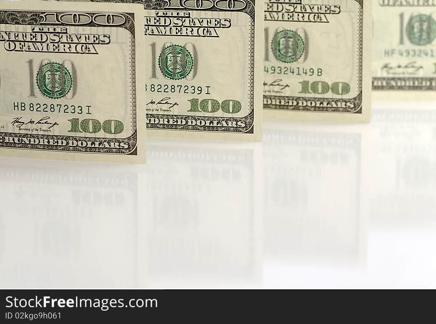 One hundred dollar notes against the white background