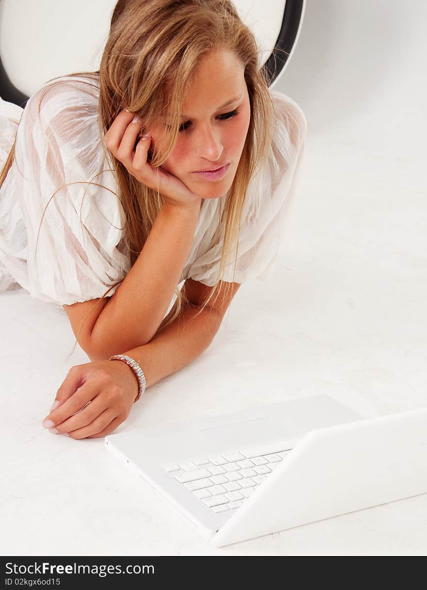 Young woman using laptop computer. Isolated against white background.