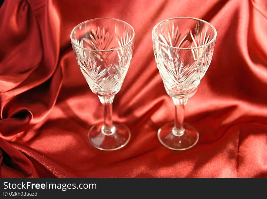 Two goblets on the red cloth background