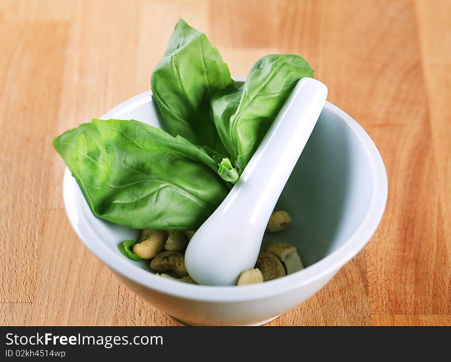 Basil and cashews in a mortar