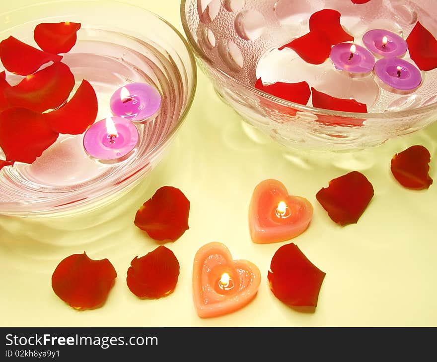 Spa lit candles among damask rose petals. Spa lit candles among damask rose petals