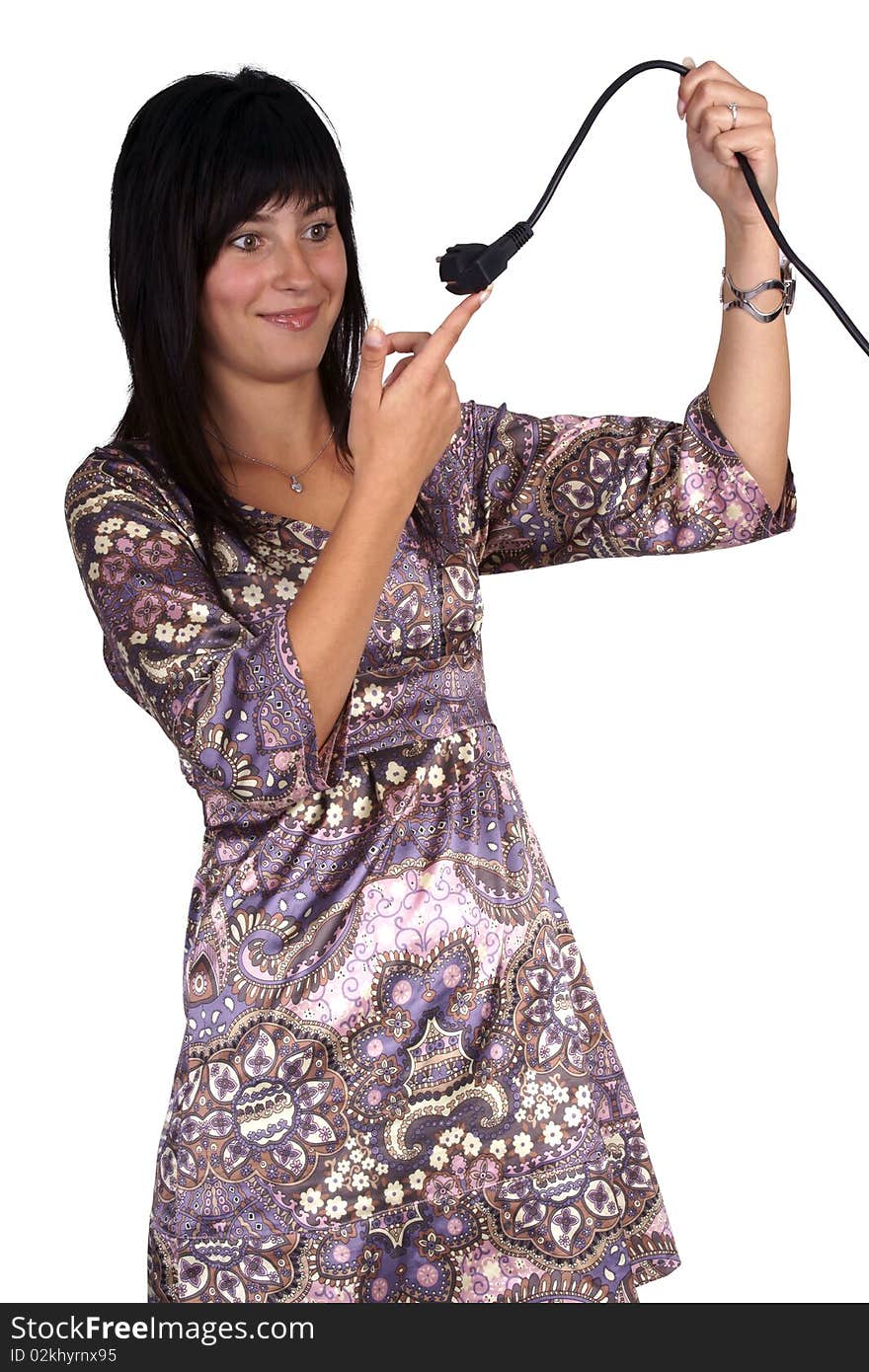 Young woman holding a power plug and looks confused. Isolated on white.