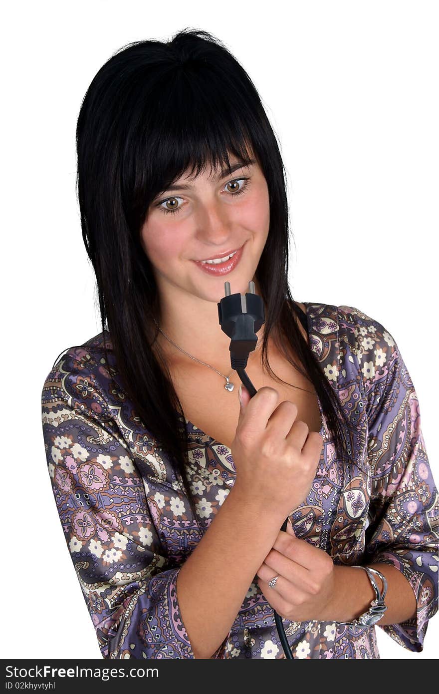 Young woman looking at the power plug and looks confused. Isolated on white.