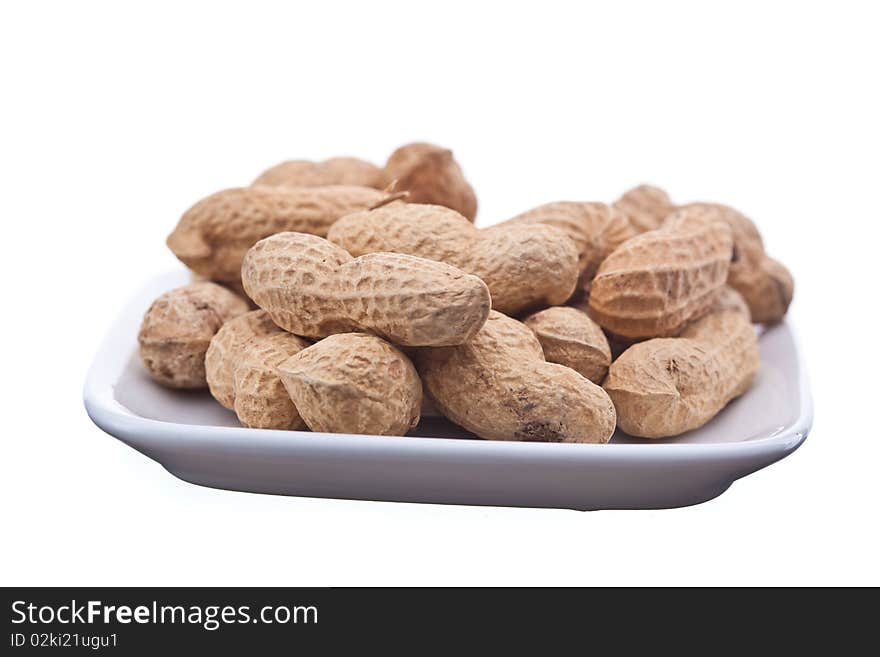 Roasted peanuts on plate isolated on white background