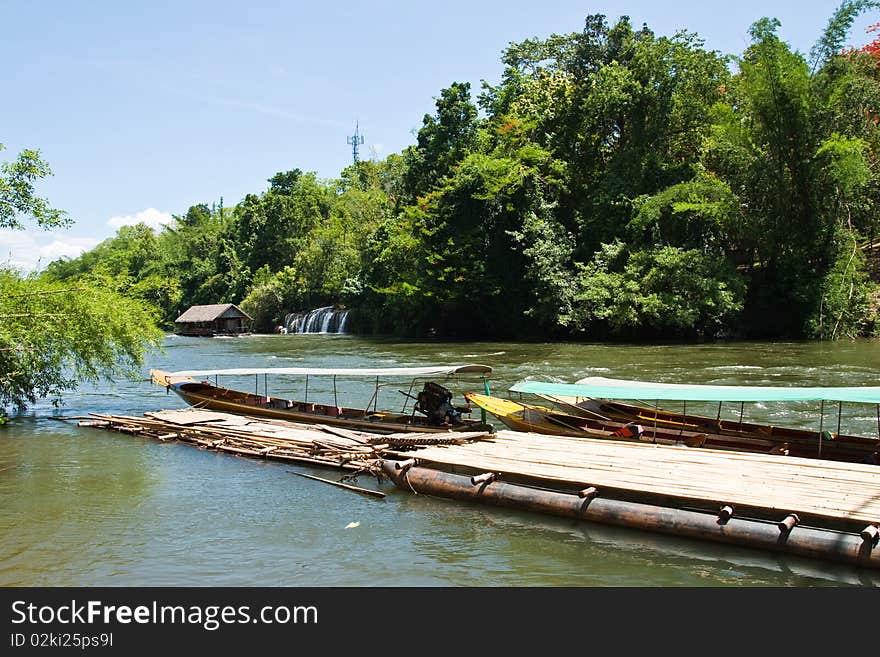 Boat with floating raft house near the waterfall. Boat with floating raft house near the waterfall