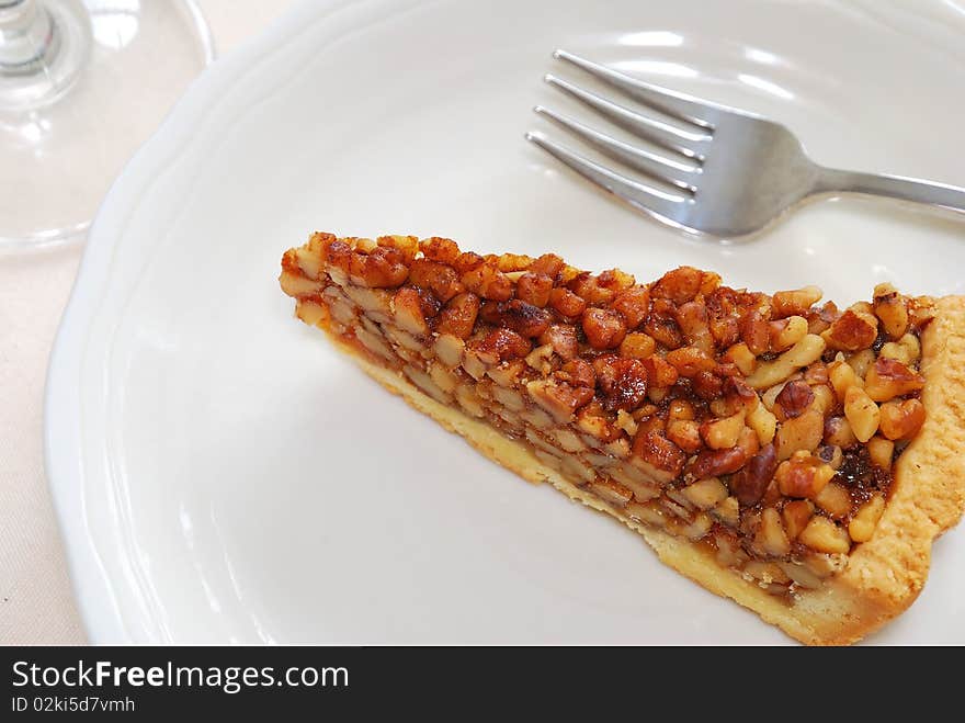 A single slice of healthy nut pie on white plate. For concepts such as food and beverage, diet and nutrition, and healthy eating. A single slice of healthy nut pie on white plate. For concepts such as food and beverage, diet and nutrition, and healthy eating.