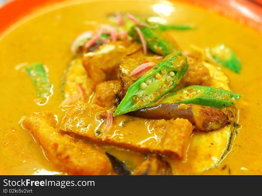 Chinese vegetarian curry cooked with mock fish meat, lady fingers and tomatos. Suitable for food and beverage, healthy lifestyle, and diet and nutrition.