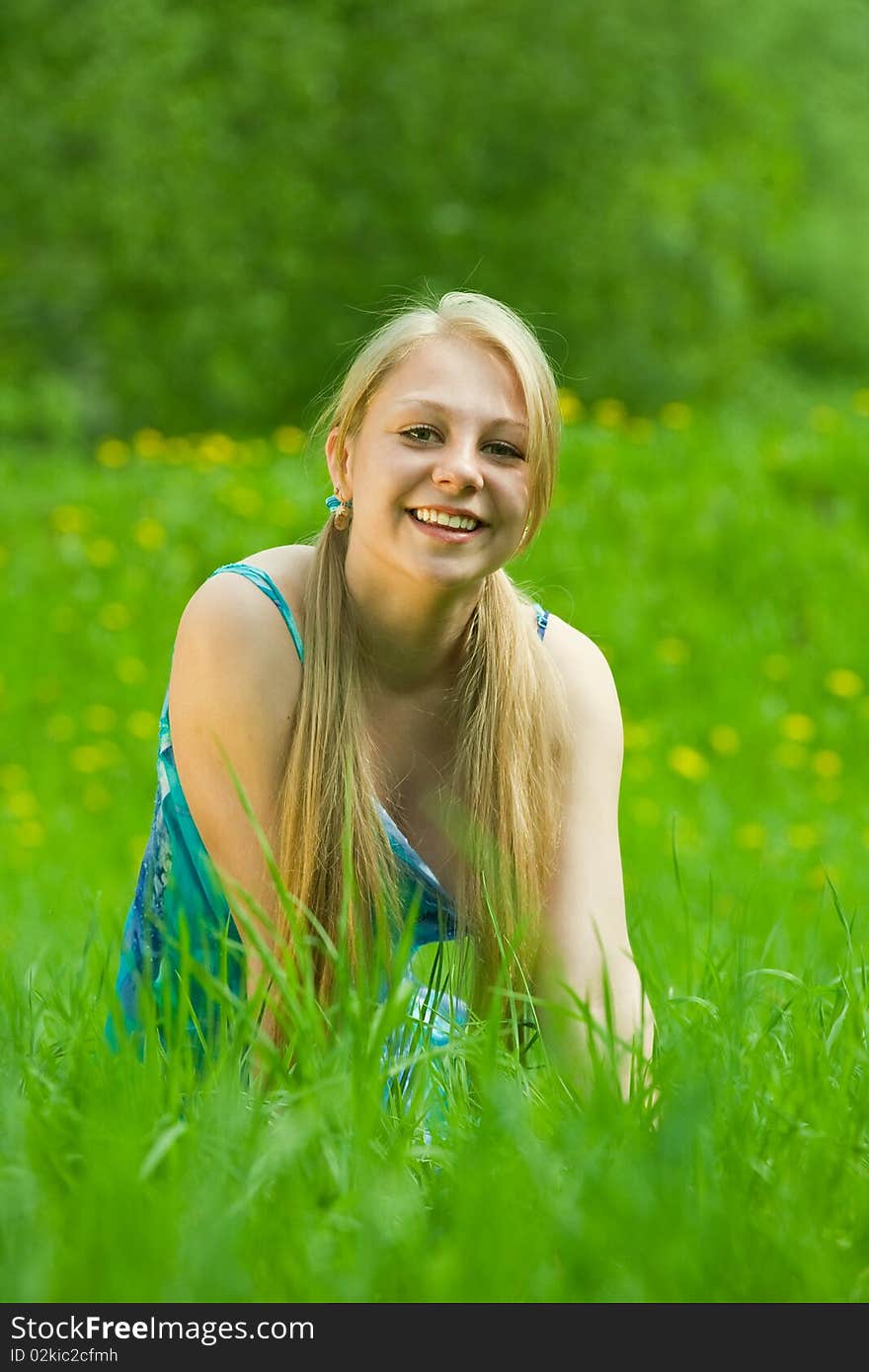 Pretty smiling  girl  relaxing outdoor  in grass