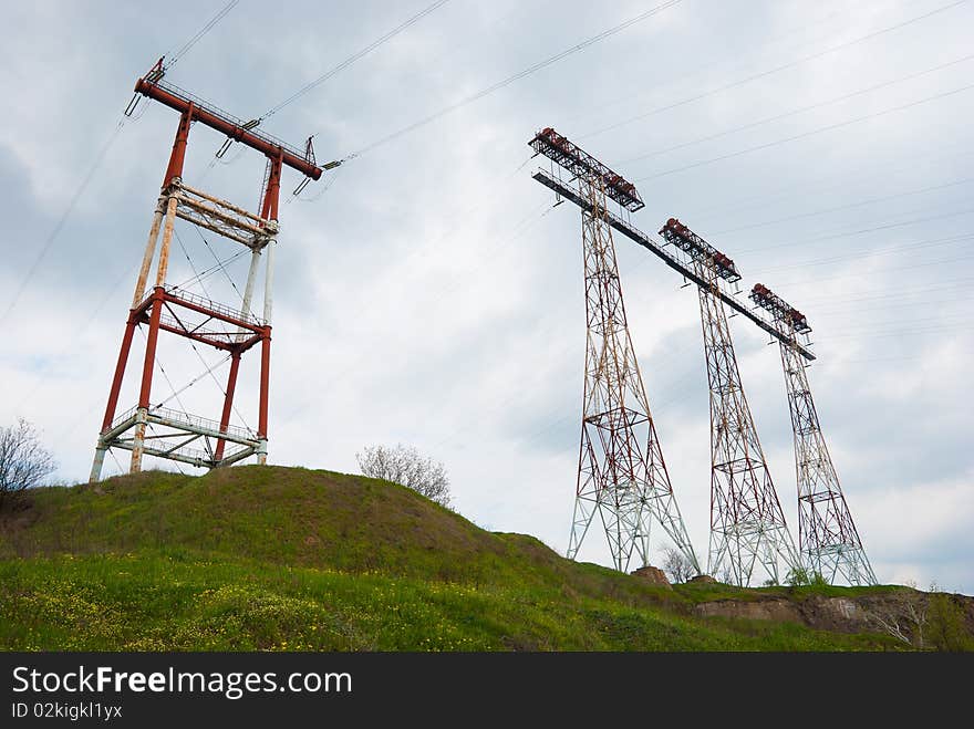 High-voltage equipment over the cloudy sky. High-voltage equipment over the cloudy sky