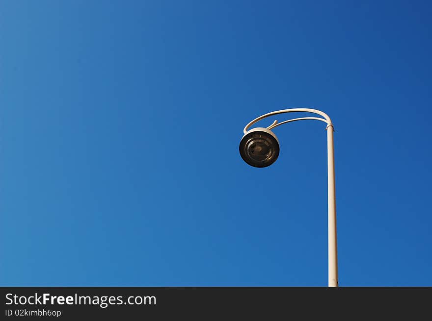 A lamp with a blue sky background