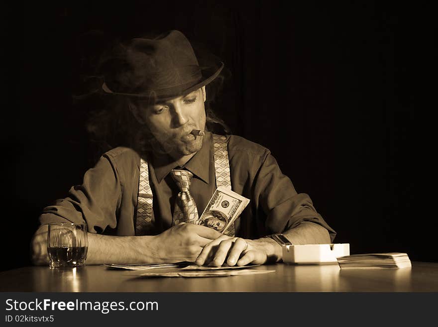 Old style photo of man playing card game and smoking cigar. Old style photo of man playing card game and smoking cigar