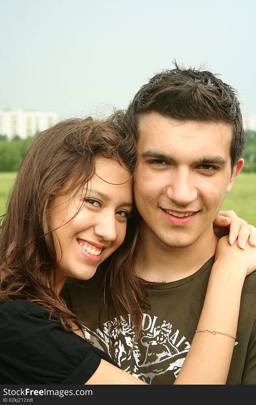 Young man and girl embracing outdoor