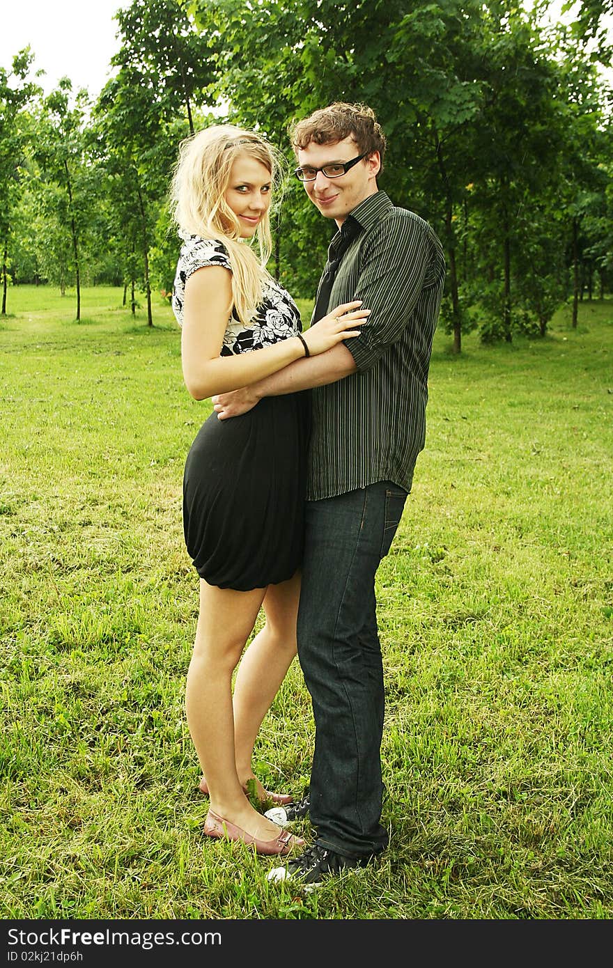 Young man and girl embracing outdoor