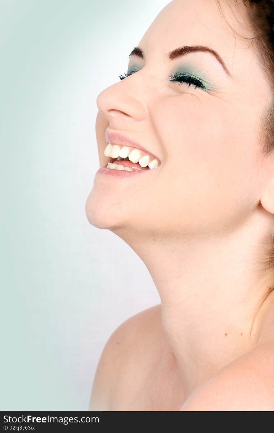 A close up of a woman throwing her head back and laughing. A close up of a woman throwing her head back and laughing.