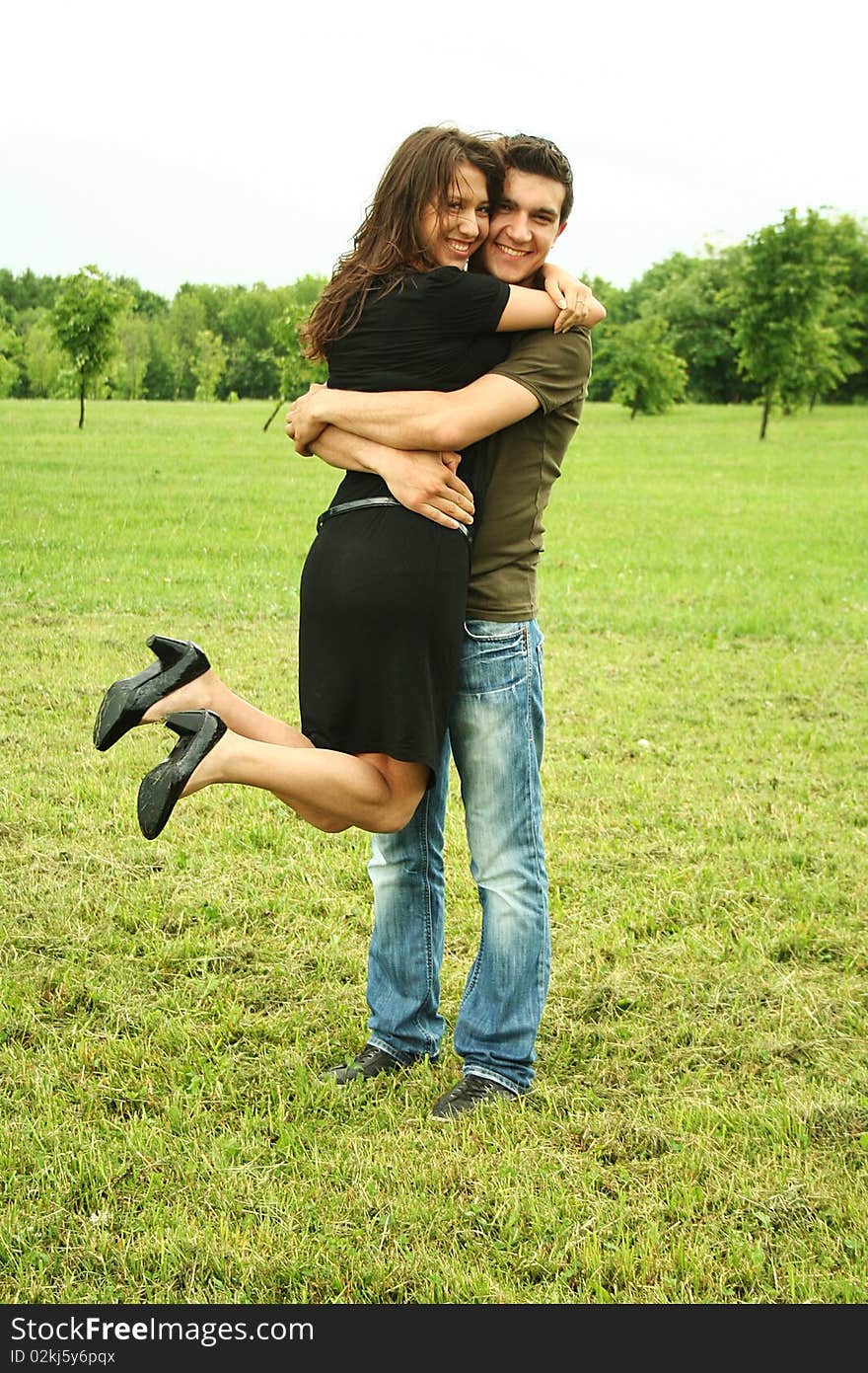 Young man and girl embracing outdoor