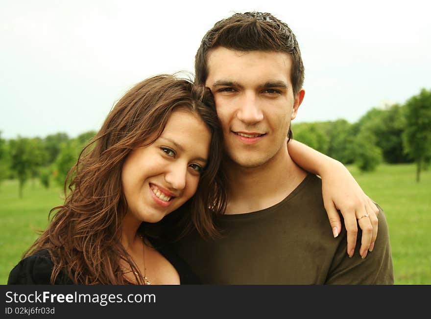 Young man and girl embracing outdoor