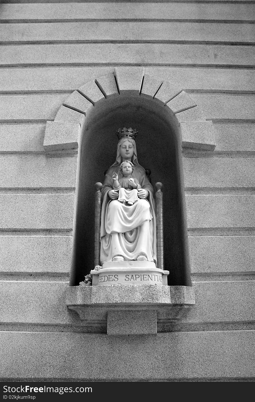 Faithful statue on the wall along the walk way. Faithful statue on the wall along the walk way