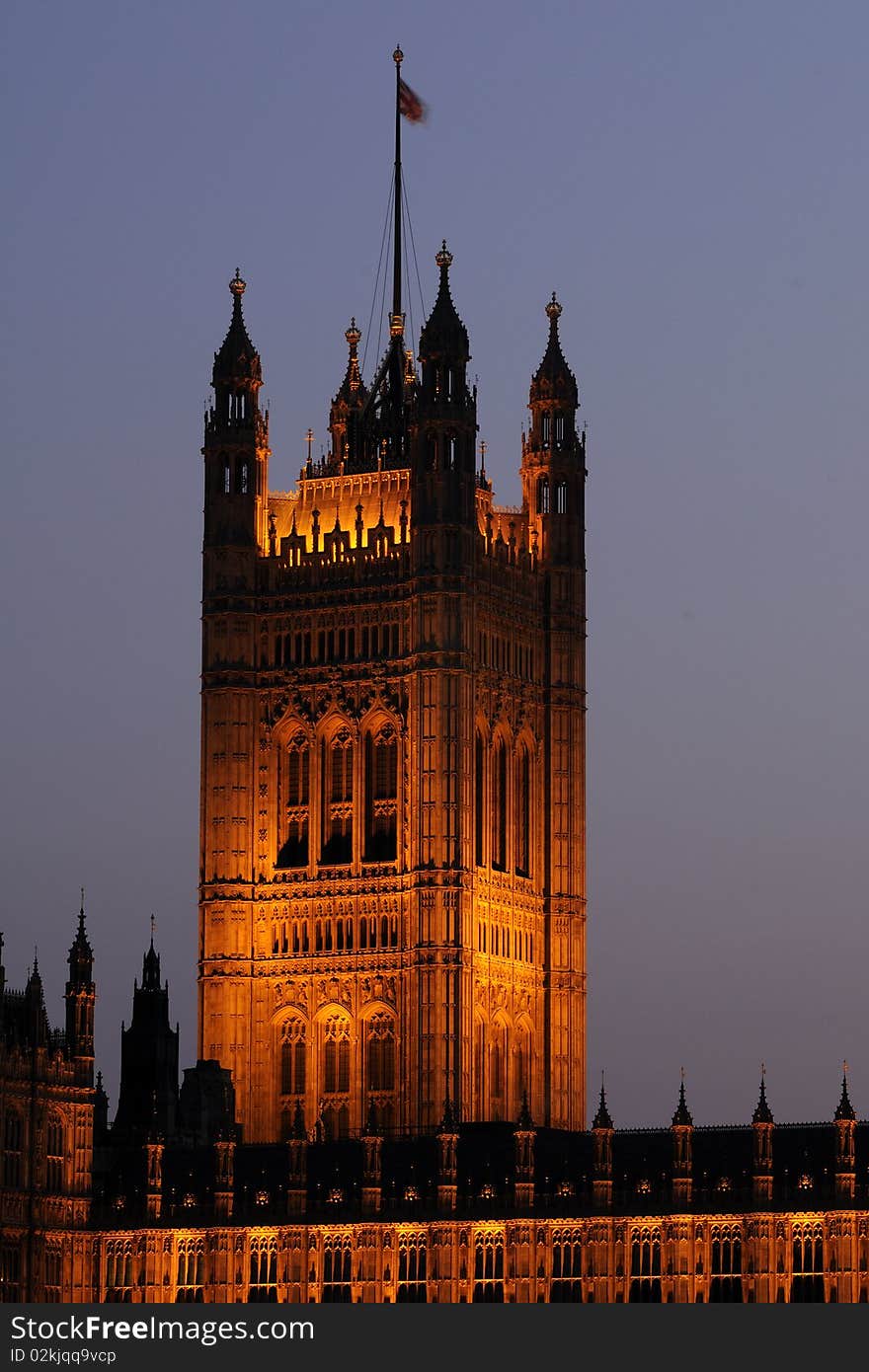 Flag on illuminated Houses of Parliament