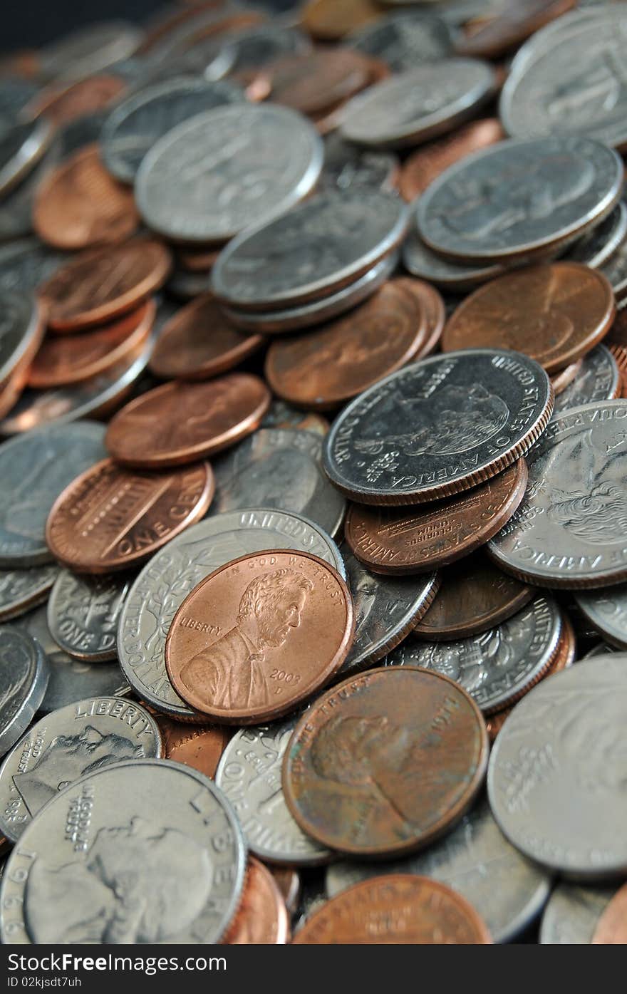 A whole bunch of American coins piled on top of one another to make this background. Shallow depth of field. A whole bunch of American coins piled on top of one another to make this background. Shallow depth of field.