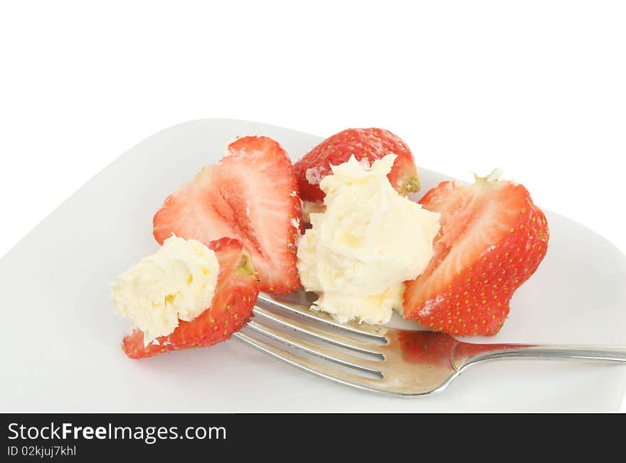 Strawberries cream and a fork on a plate