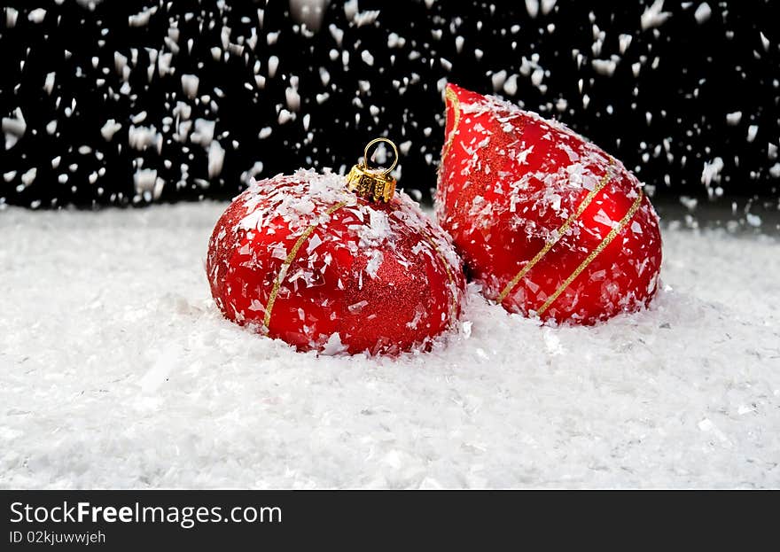 Snow Falling On Two Red Ornaments