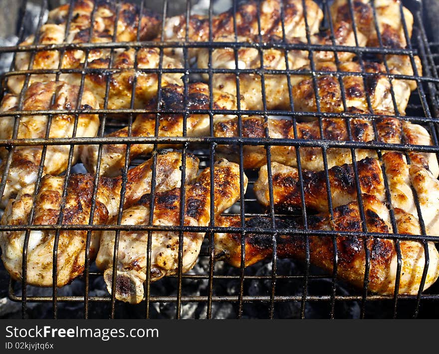 Appetizing chicken legs with crispy crust, grilled on old grill. Appetizing chicken legs with crispy crust, grilled on old grill